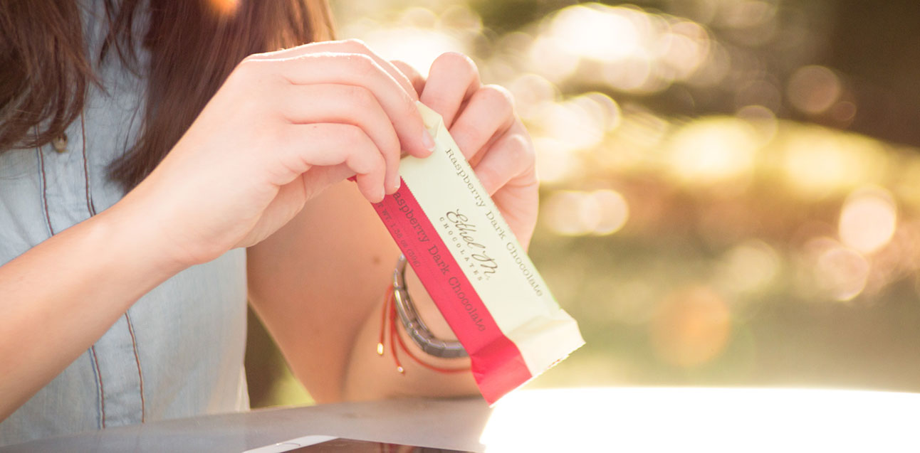 Woman unwrapping a chocolate bar