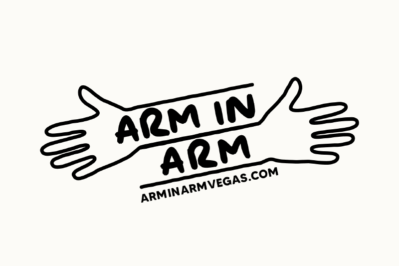 Two illustrated arms with hands outstretched, reading “Arm in Arm” and “arminarmvegas.com” between them.
