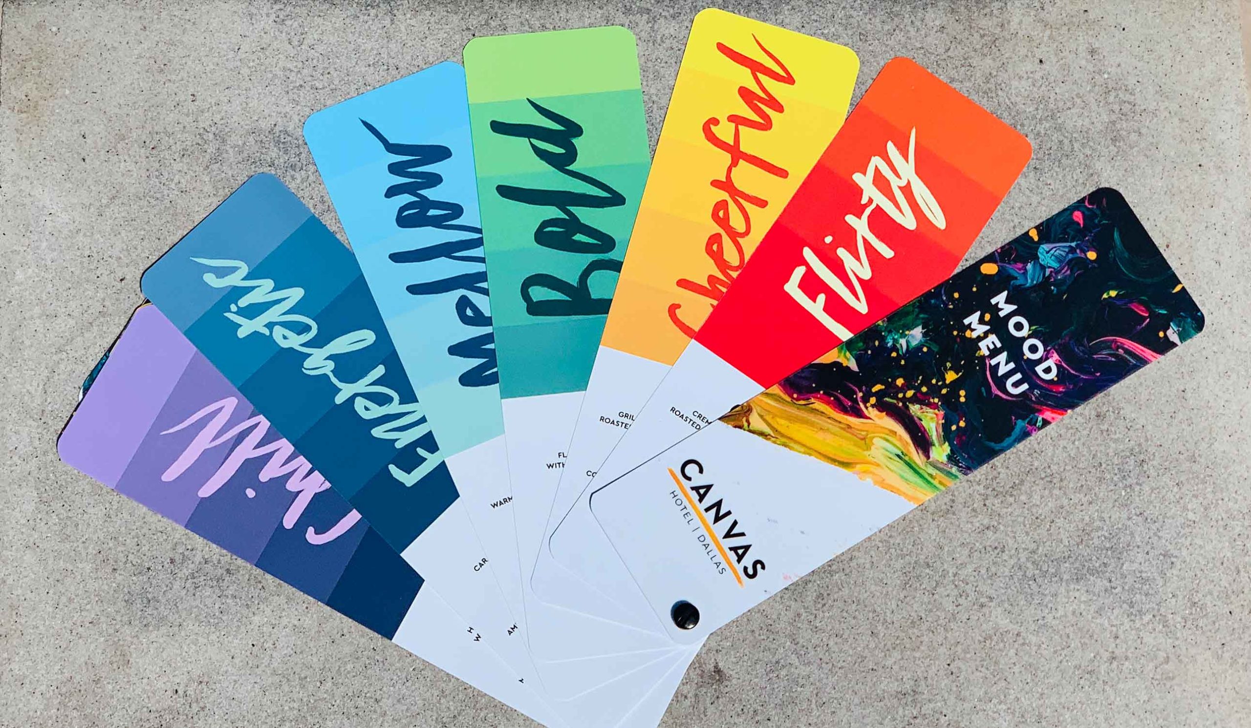 A fan of colorful paint swatches labeled with moods like flirty, cheerful, bold, mellow, and funky.