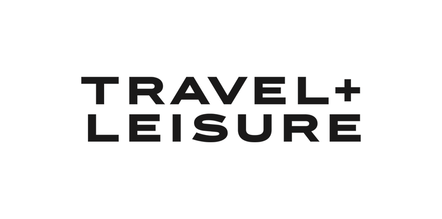 Black text TRAVEL + LEISURE in bold, uppercase letters on a light gray background.